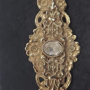 Elegant Gold Floral Brooch with Center Stone